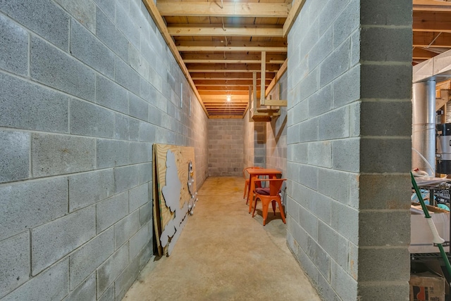 unfinished below grade area featuring concrete block wall