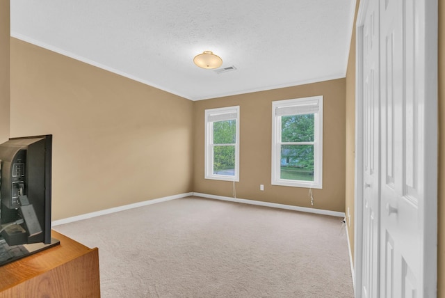 unfurnished living room featuring ornamental molding, carpet flooring, and baseboards