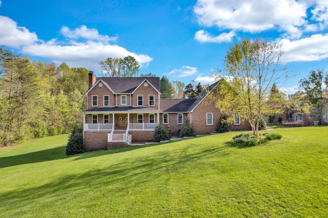 view of front of property with a front lawn, a chimney, brick siding, and covered porch