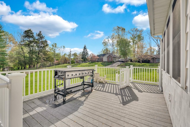 wooden terrace featuring a lawn