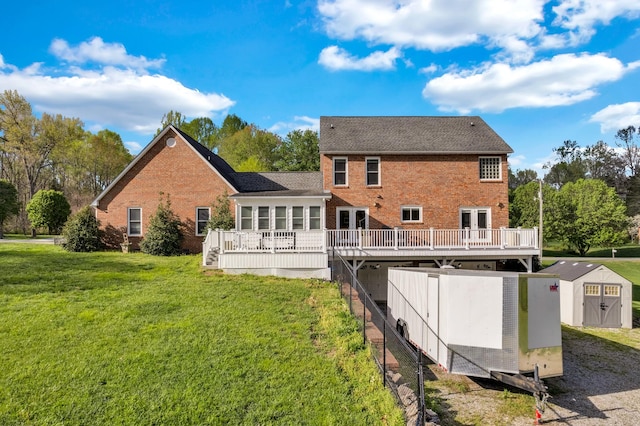 back of house with a storage shed, brick siding, an outdoor structure, and a wooden deck