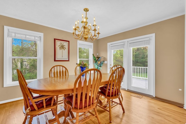 dining room featuring light wood finished floors, crown molding, a healthy amount of sunlight, and visible vents