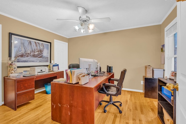 home office featuring crown molding, baseboards, a ceiling fan, and light wood-style floors
