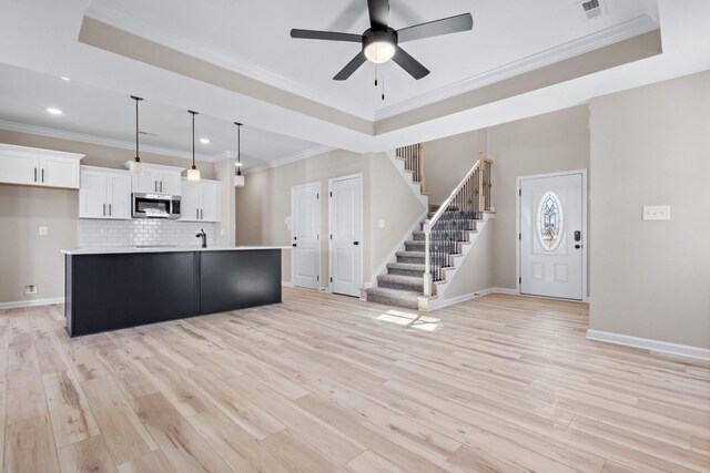 2531 Rafiki Dr, Clarksville, TN 37042 - kitchen with stainless steel microwave, decorative backsplash, visible vents, white cabinets, and a ceiling fan