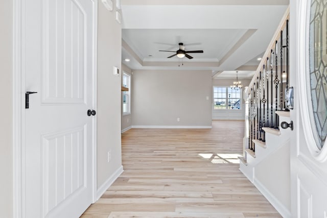 2531 Rafiki Dr, Clarksville, TN 37042 - entrance foyer with light wood-style flooring, baseboards, stairs, a raised ceiling, and ceiling fan with notable chandelier