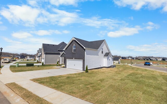 2531 Rafiki Dr, Clarksville, TN 37042 - view of home's exterior with driveway, an attached garage, central AC, a residential view, and a lawn