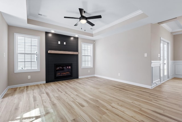 2531 Rafiki Dr, Clarksville, TN 37042 - unfurnished living room with crown molding, a tray ceiling, light wood-style floors, and visible vents