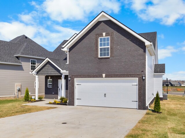 2531 Rafiki Dr, Clarksville, TN 37042 - view of front of home featuring brick siding, a garage, a front lawn, and concrete driveway