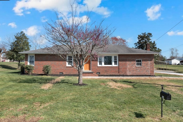 exterior space with brick siding, a yard, and a chimney