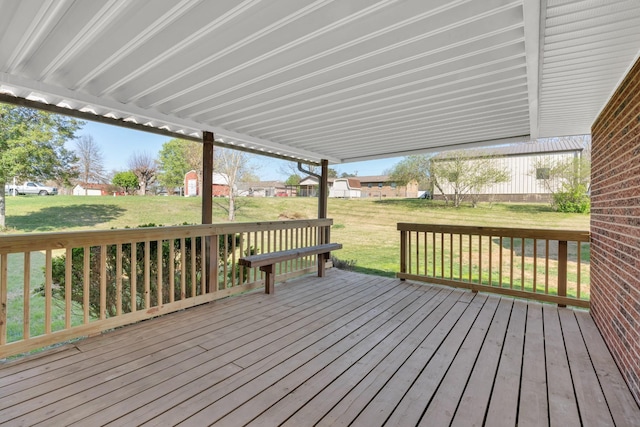 wooden terrace featuring a yard