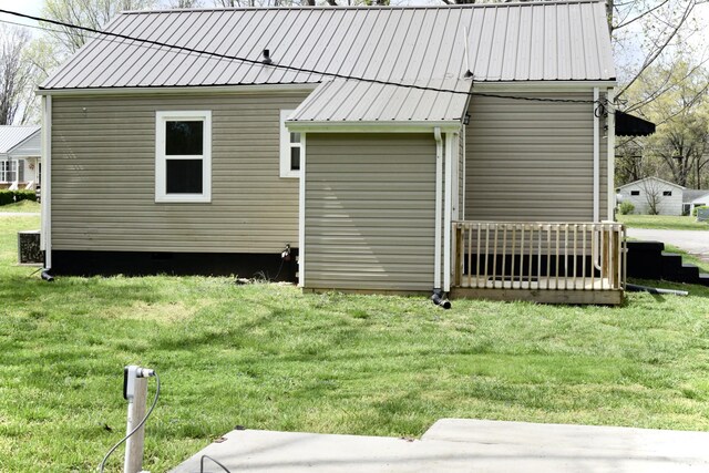 view of home's exterior featuring a lawn and metal roof