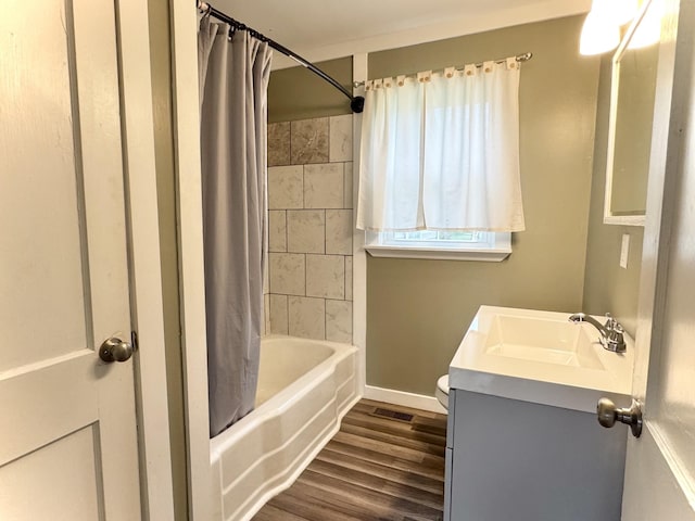 full bath with vanity, baseboards, visible vents, shower / bath combination with curtain, and wood finished floors