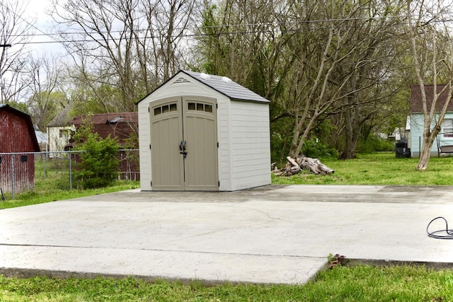 view of shed featuring fence