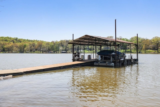 dock area with a water view and boat lift