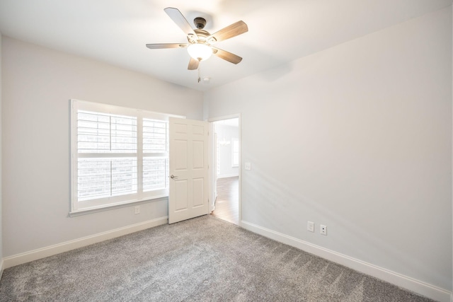 carpeted empty room with baseboards and ceiling fan