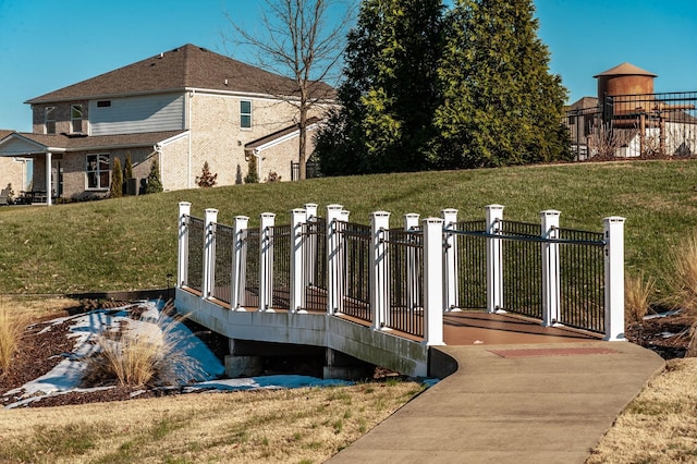 view of dock featuring fence and a yard