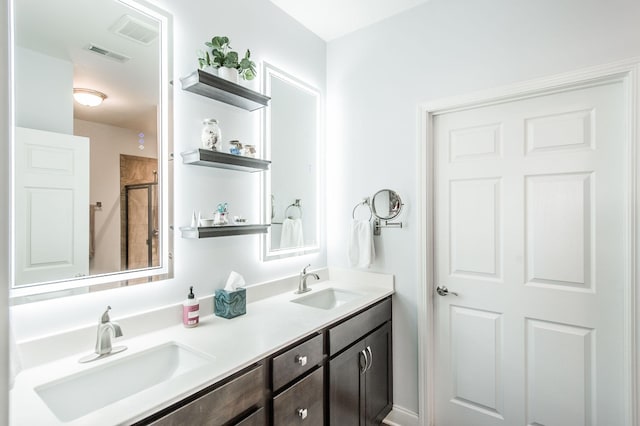 bathroom with visible vents, a sink, and double vanity
