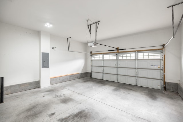 garage with a garage door opener and electric panel