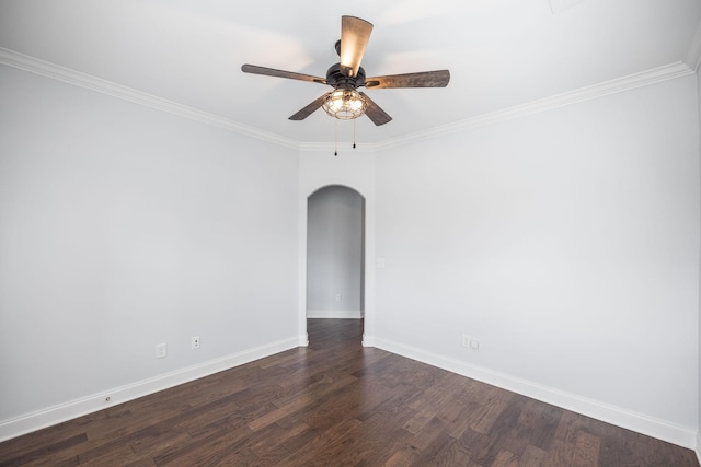 spare room with crown molding, baseboards, arched walkways, dark wood-style floors, and a ceiling fan