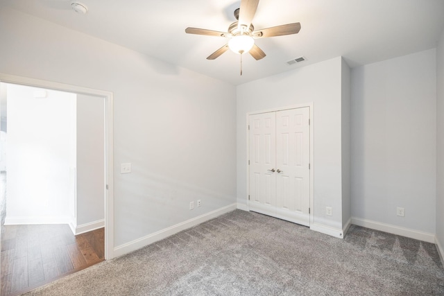 unfurnished bedroom with baseboards, visible vents, a closet, and carpet