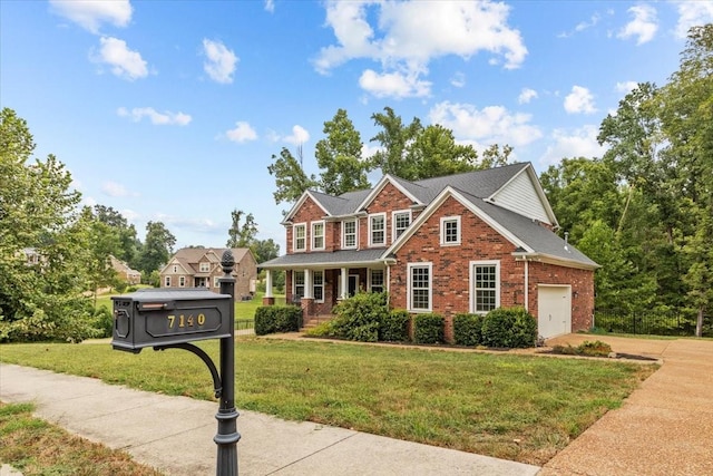 colonial house featuring a front yard, roof with shingles, concrete driveway, brick siding, and a garage