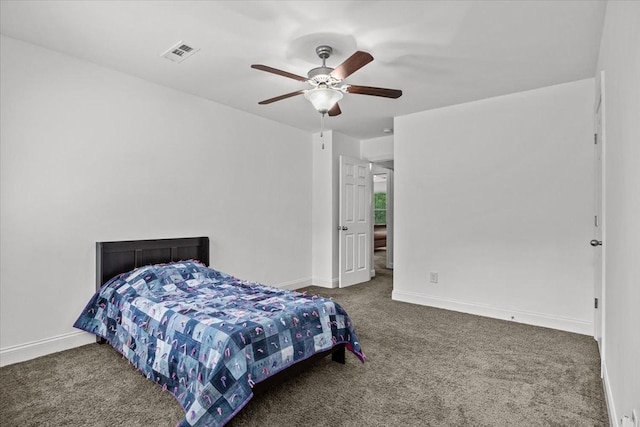 carpeted bedroom featuring baseboards, ceiling fan, and visible vents