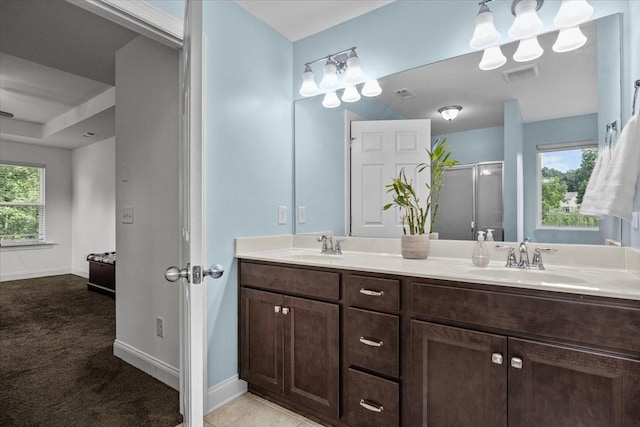 full bath with visible vents, a sink, a stall shower, and plenty of natural light