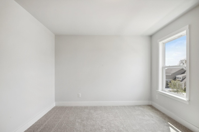 empty room with light carpet and baseboards