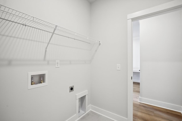laundry room featuring washer hookup, baseboards, wood finished floors, laundry area, and hookup for an electric dryer