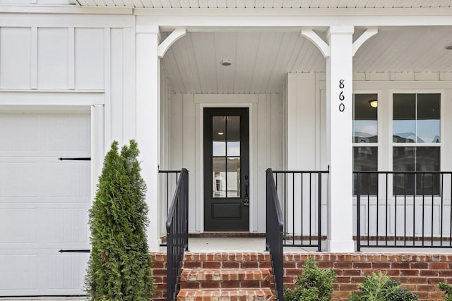entrance to property with a garage and board and batten siding