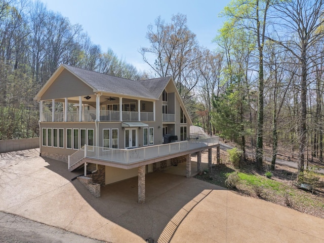 48 Old Pump Station Rd, Linden, TN 37096 - rear view of property with a balcony, concrete driveway, roof with shingles, and ceiling fan