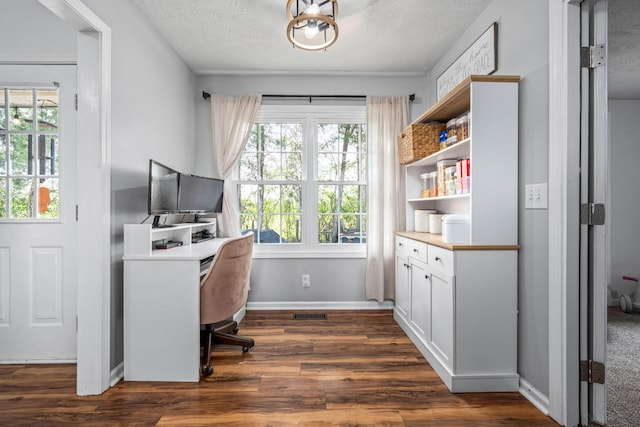 home office featuring visible vents, dark wood-type flooring, baseboards, and a textured ceiling