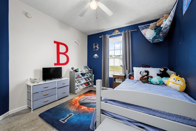bedroom with baseboards, a ceiling fan, carpet, and a textured ceiling