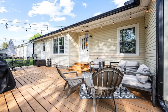 wooden deck with entry steps and outdoor dining space