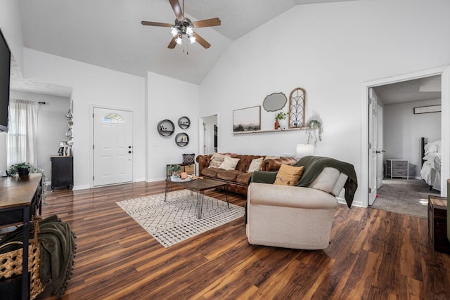living room featuring a ceiling fan, high vaulted ceiling, baseboards, and wood finished floors