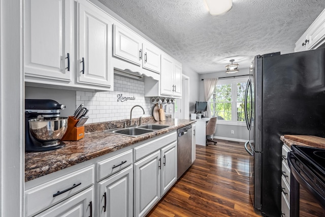 kitchen featuring stainless steel appliances, tasteful backsplash, dark wood-type flooring, white cabinetry, and a sink