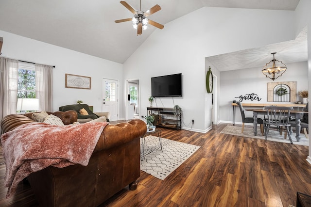 living room featuring wood finished floors, high vaulted ceiling, ceiling fan with notable chandelier, and a wealth of natural light