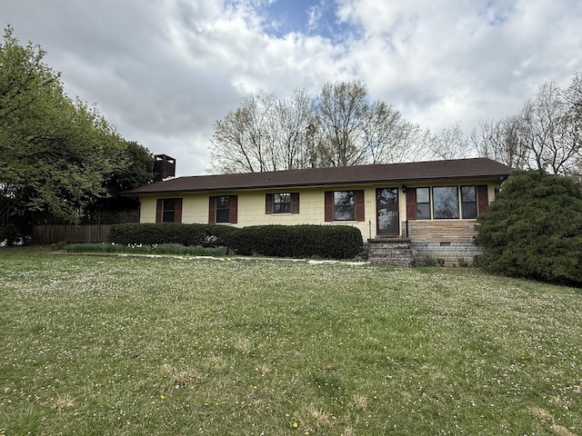 ranch-style house with crawl space, a chimney, a front yard, and fence