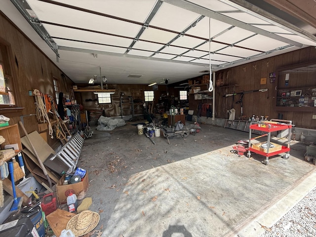 garage featuring wood walls and a workshop area
