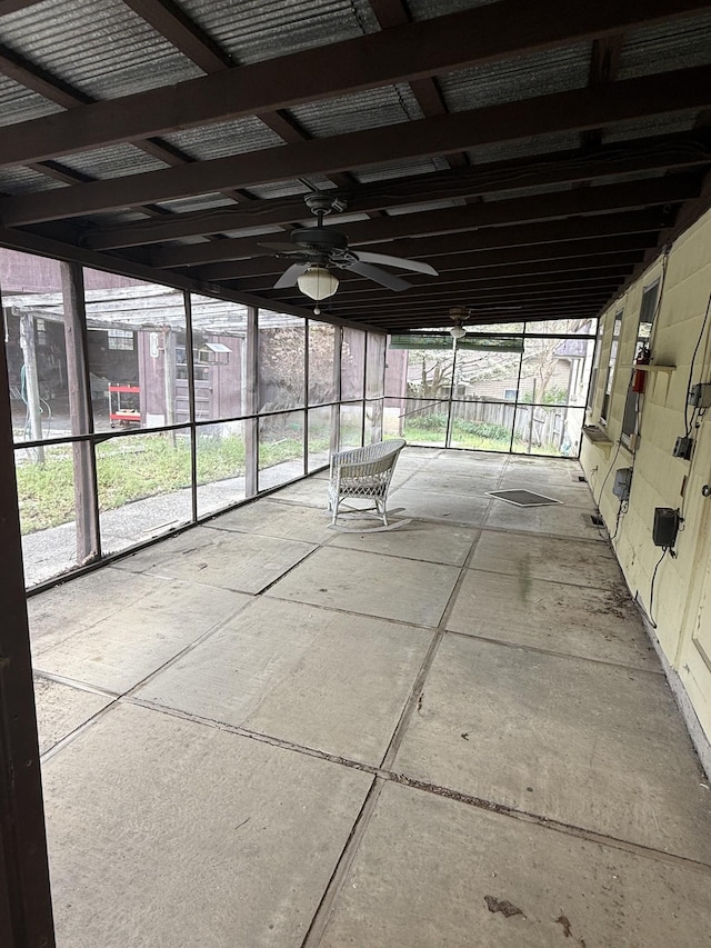unfurnished sunroom with ceiling fan