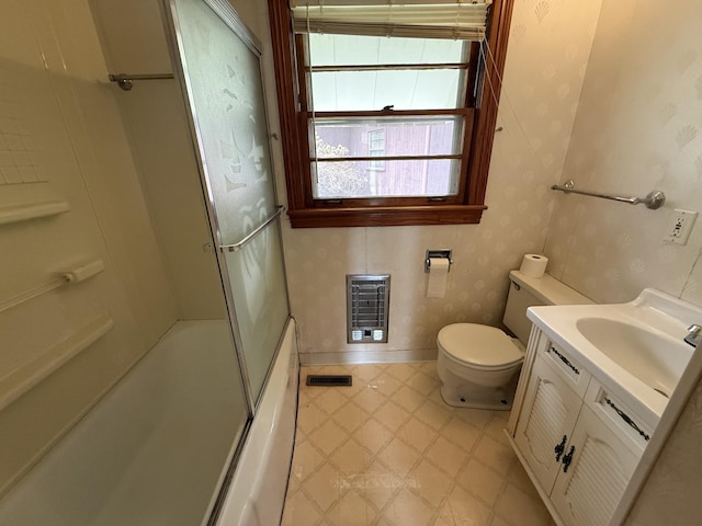 bathroom with visible vents, baseboards, wallpapered walls, vanity, and heating unit
