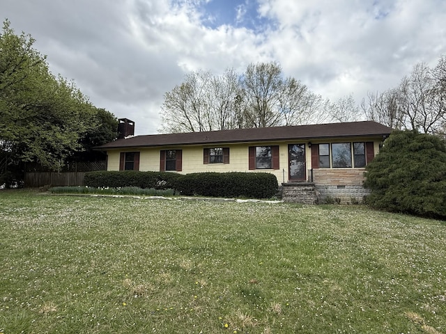 ranch-style home featuring a front yard, crawl space, fence, and a chimney