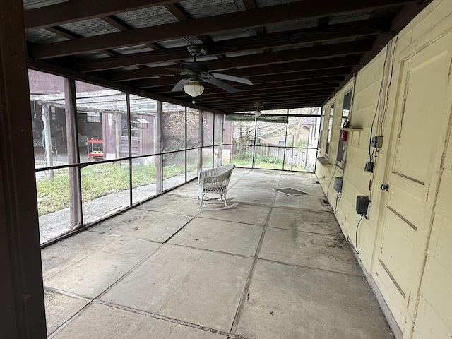 unfurnished sunroom featuring ceiling fan