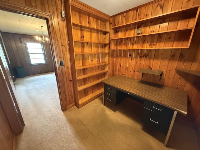 office featuring light carpet, wooden walls, and a chandelier