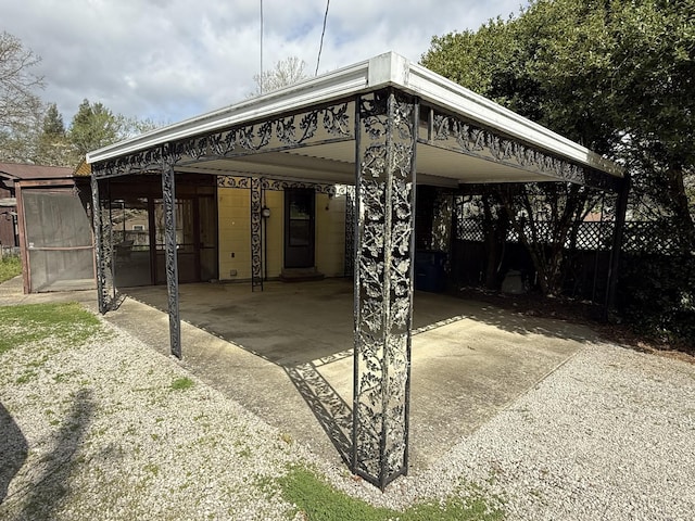 view of parking / parking lot featuring driveway and a carport