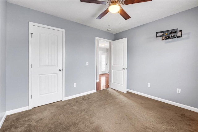 unfurnished bedroom featuring baseboards, carpet floors, and a ceiling fan