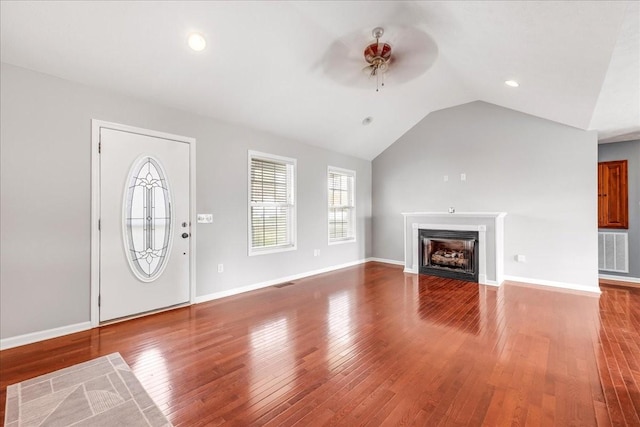 entryway featuring ceiling fan, visible vents, vaulted ceiling, and hardwood / wood-style flooring