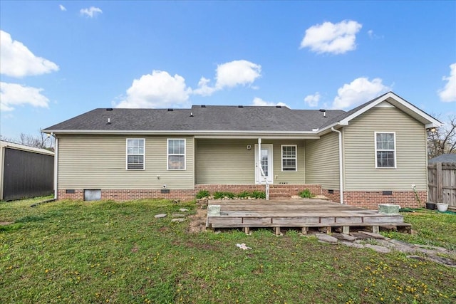 rear view of property featuring fence, crawl space, a yard, and a deck