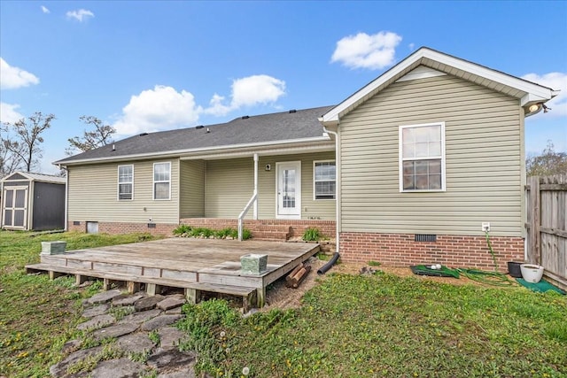 rear view of house featuring a shed, an outbuilding, a deck, fence, and crawl space