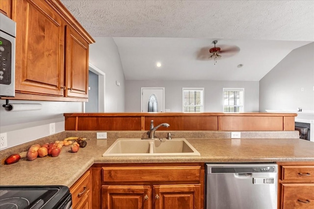 kitchen with lofted ceiling, a sink, brown cabinetry, and appliances with stainless steel finishes
